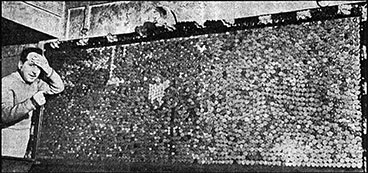 image of Charles Gibson starting to take pennies of a mirror in 1955.